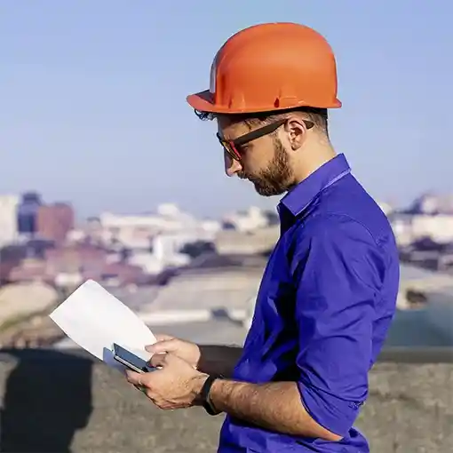 Proget mobility management for construction, engineer with construction plan and mobile device