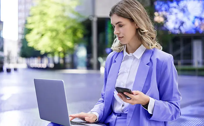 corporate woman working using laptop and mobile phone