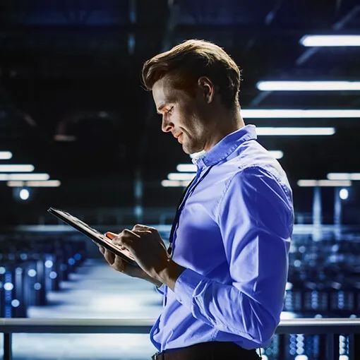 administrator with a tablet in the server room